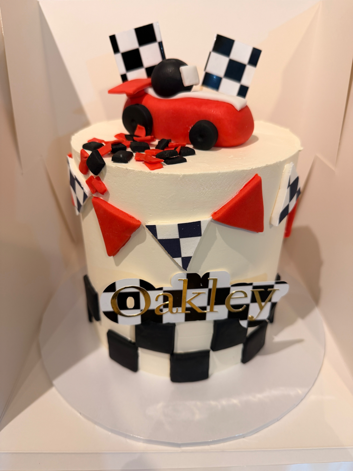Oakley personalised birthday cake with checkered detail and bunting