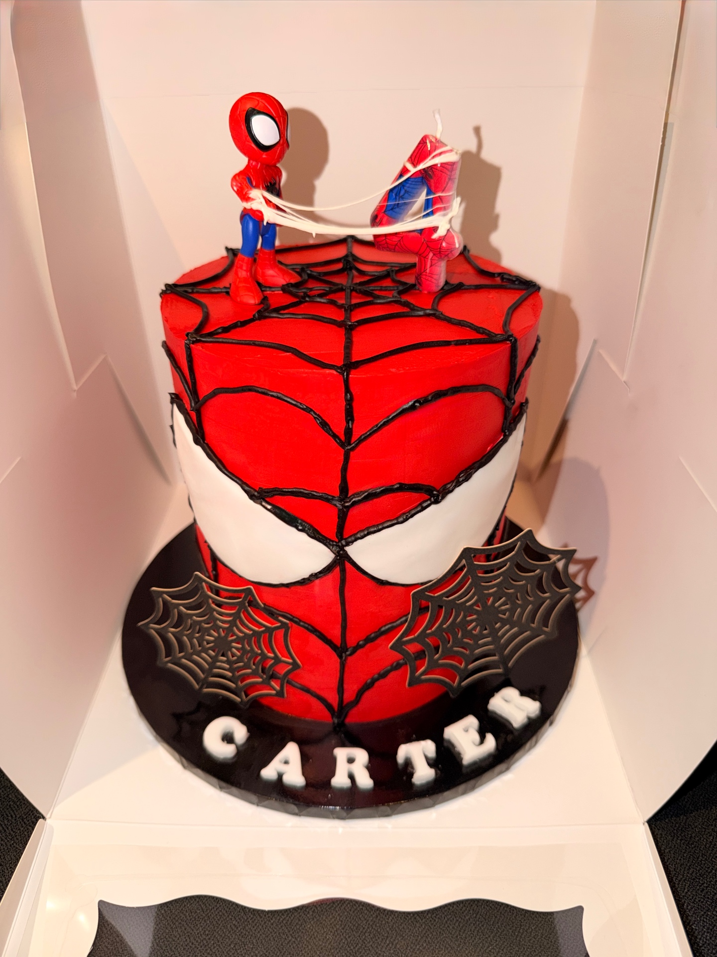 Carter's Spider-Man birthday cake with hand-piped web design