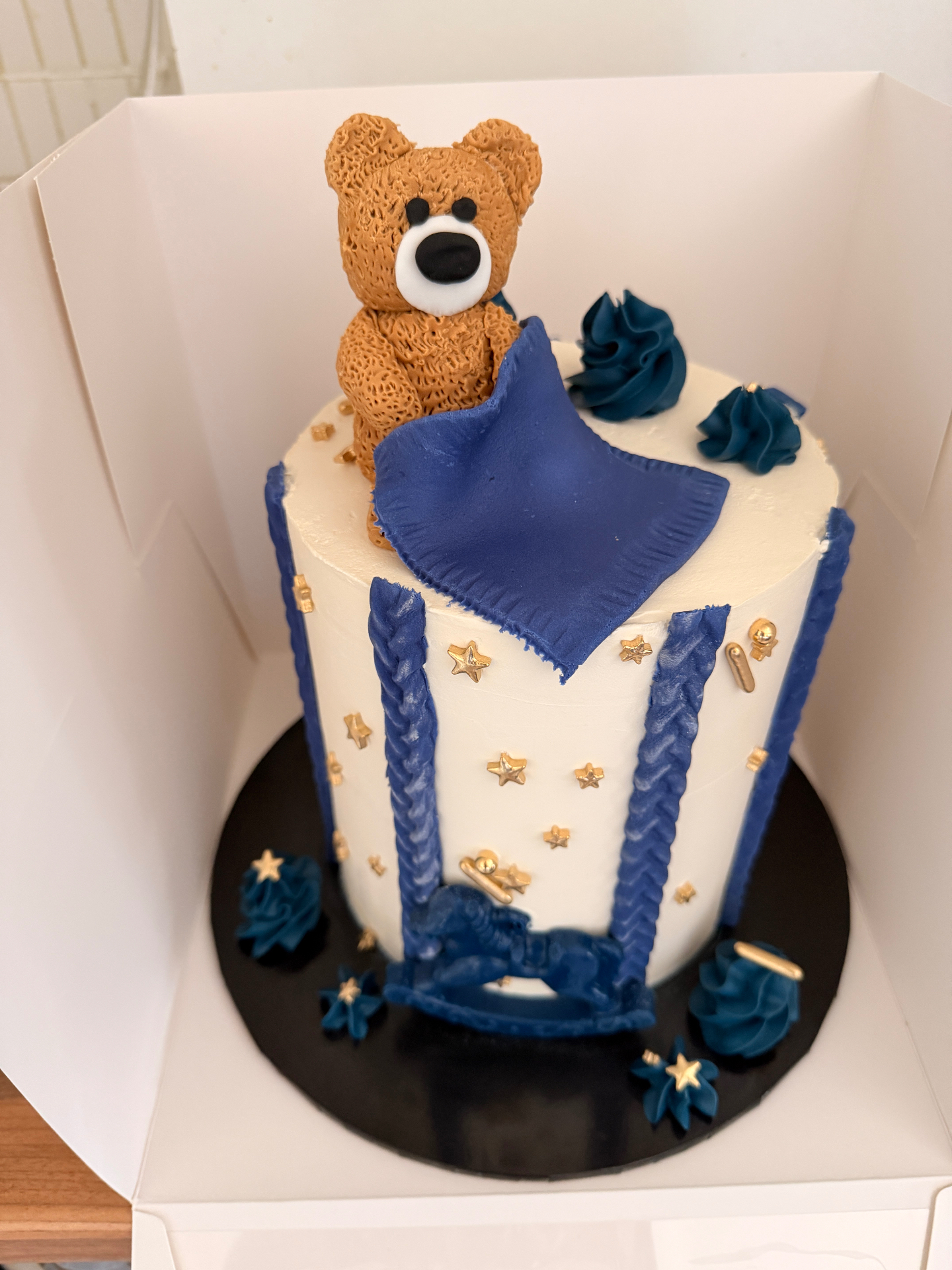 Teddy bear cake with navy blanket and gold stars