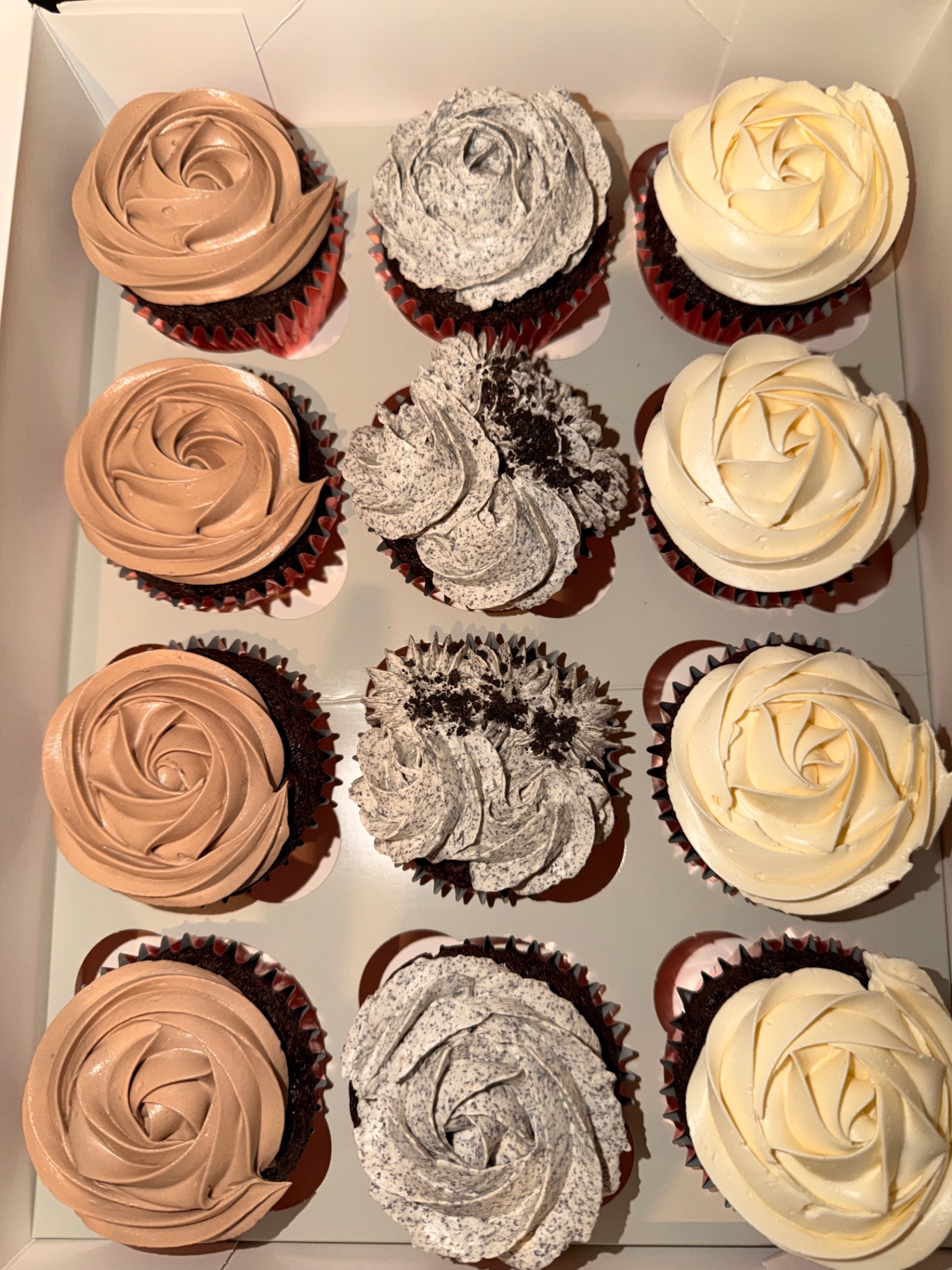 Classic chocolate cupcakes with chocolate, cookies-and-cream and vanilla buttercream rosettes